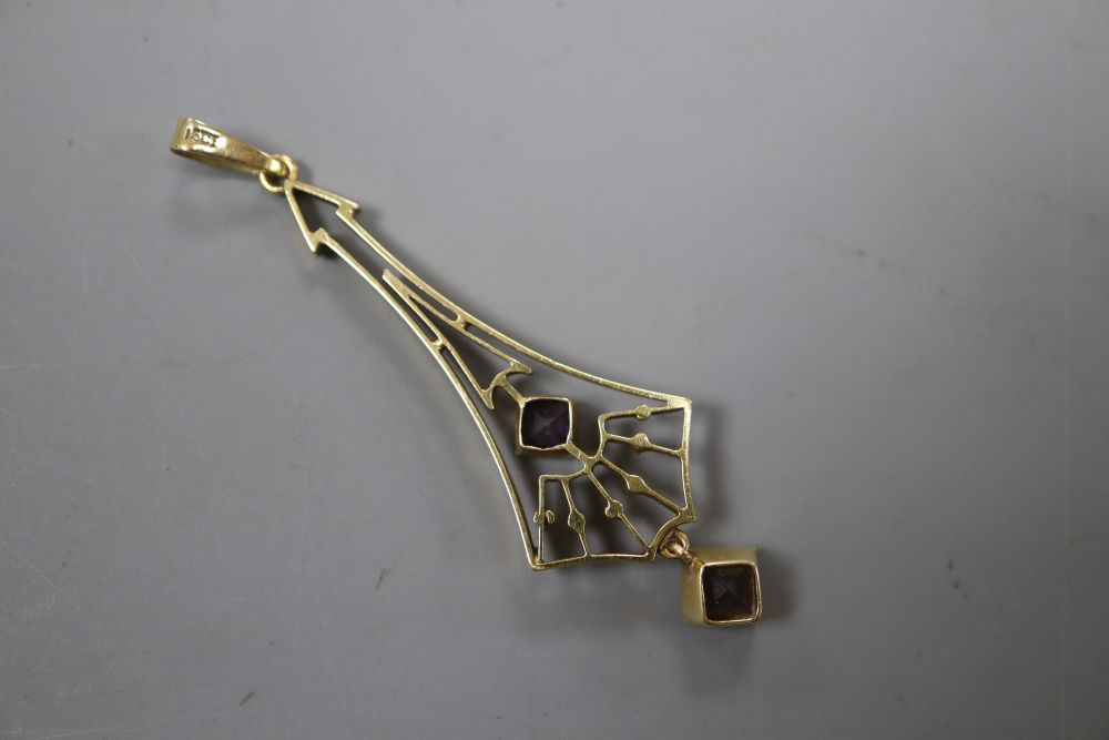 An Edwardian Arts & Crafts 15ct and two stone amethyst? set drop pendant, overall 52mm, gross 2.5 grams.